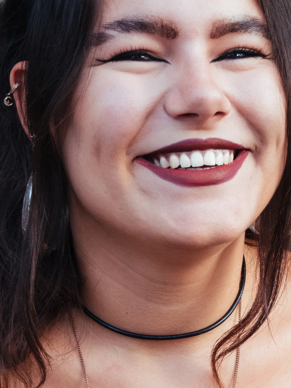 Portrait of a smiling woman wearing a black choker